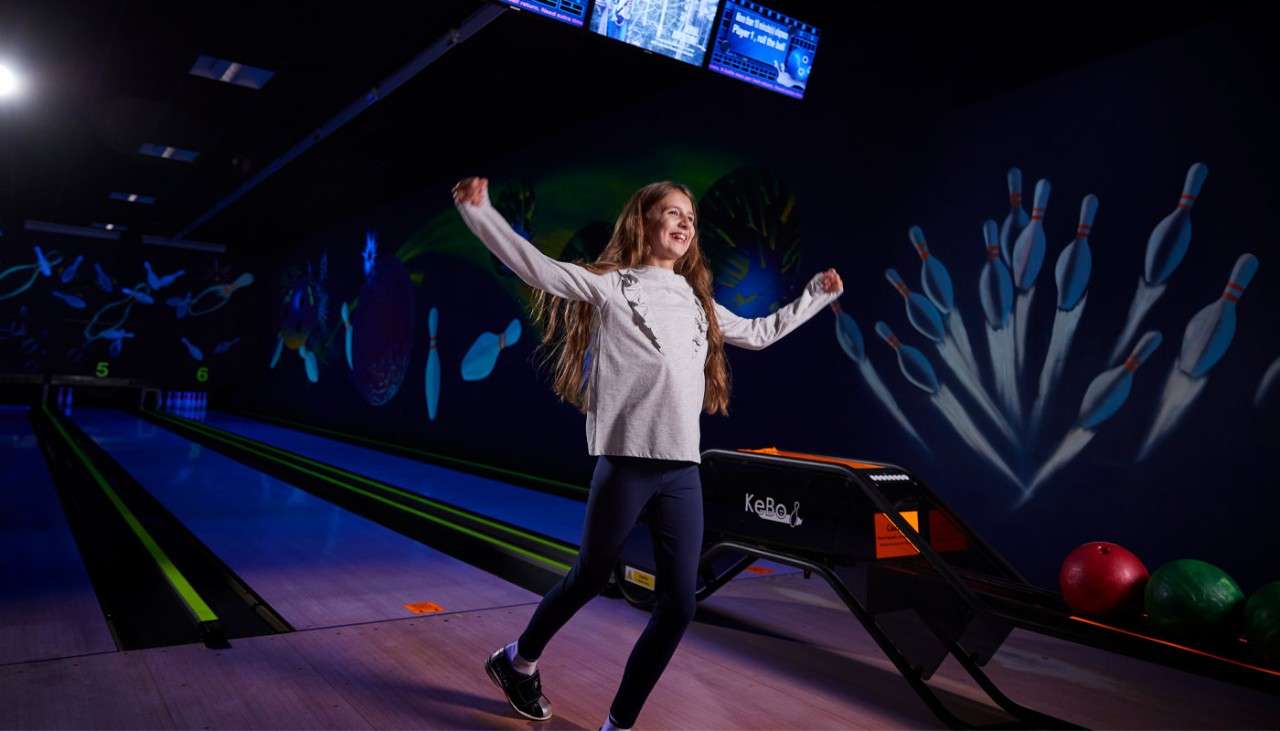 Girl celebrating after bowling