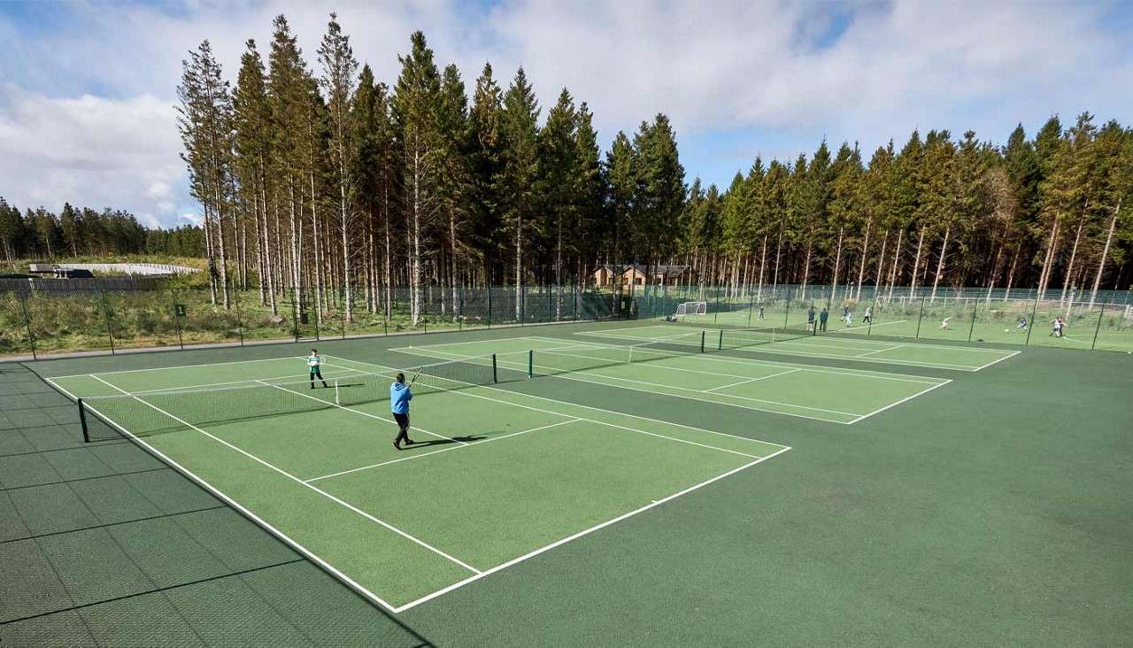 Outdoor Tennis Courts where people are playing
