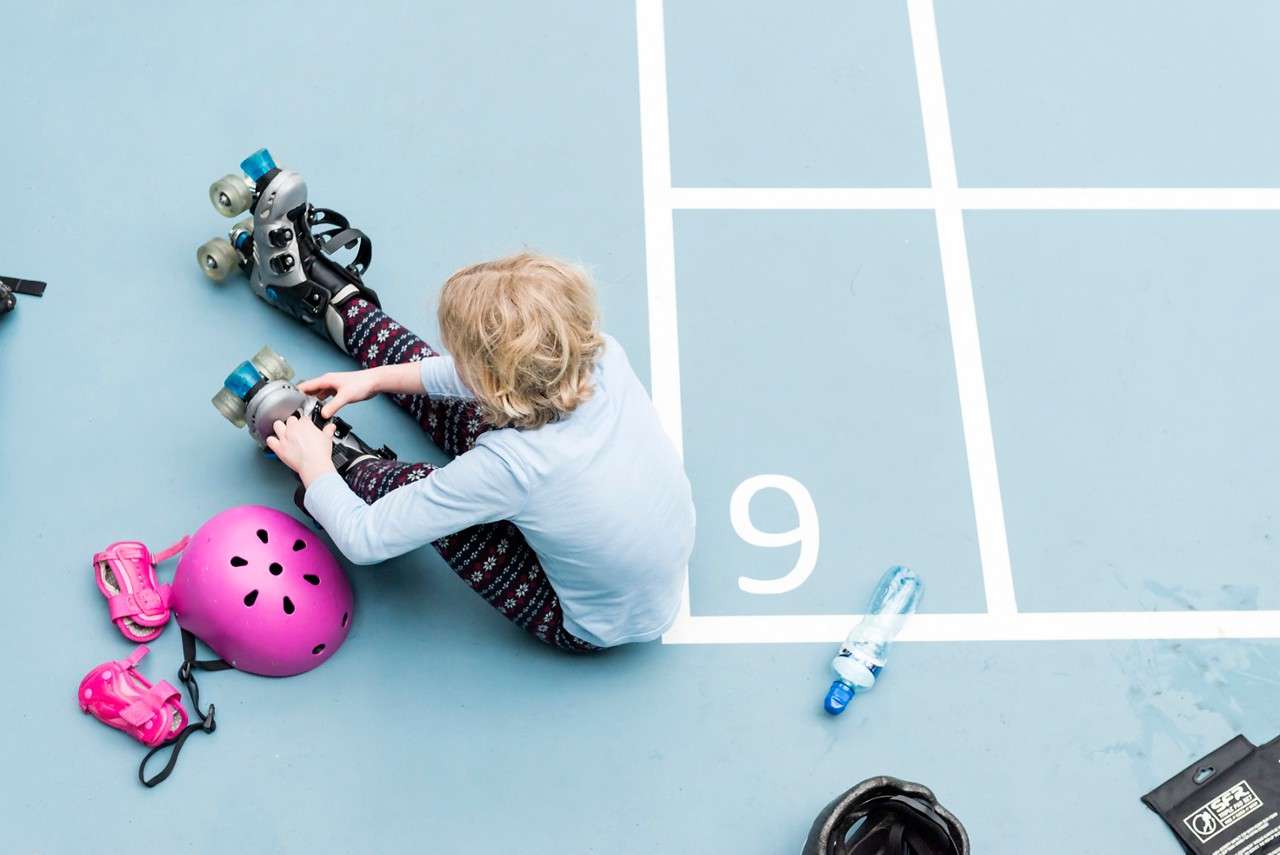 A girl putting on skates