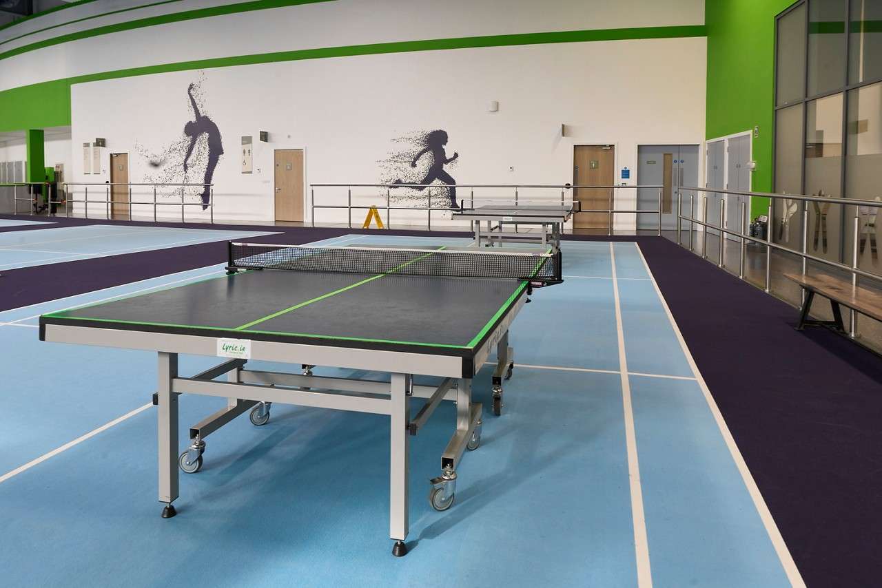 Table Tennis tables in a sports hall.