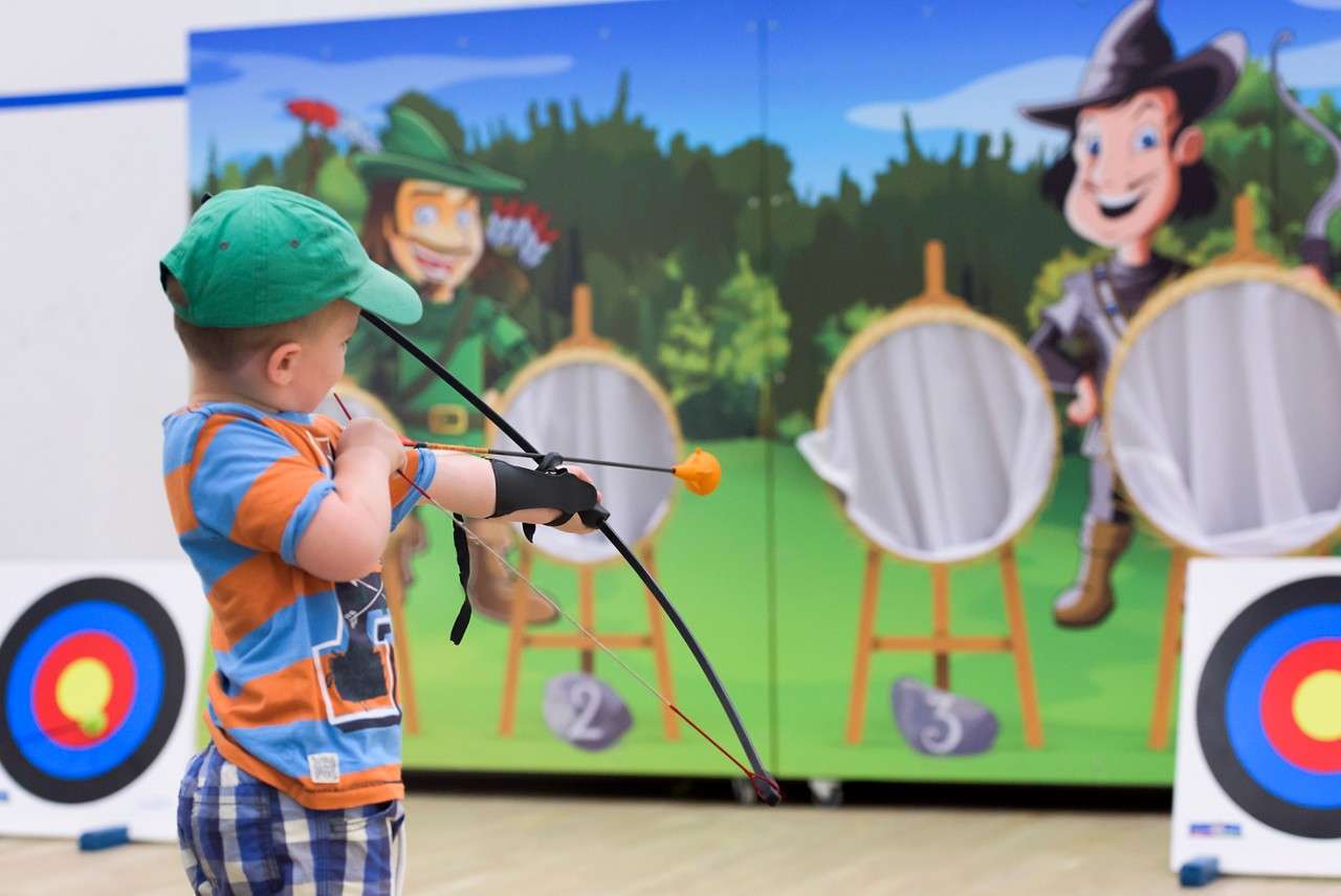 A little boy ready to shoot an arrow
