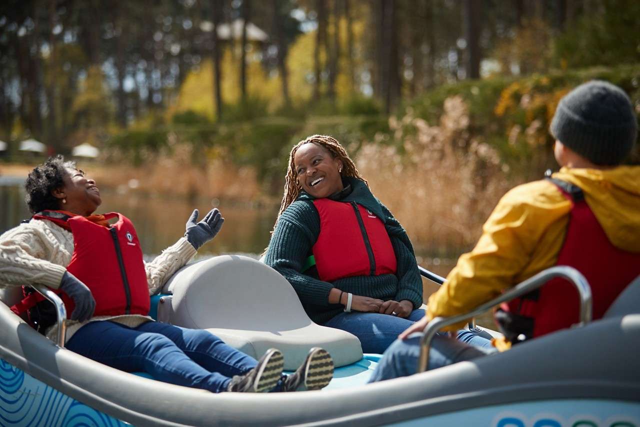 People looking animated in their electric boat.