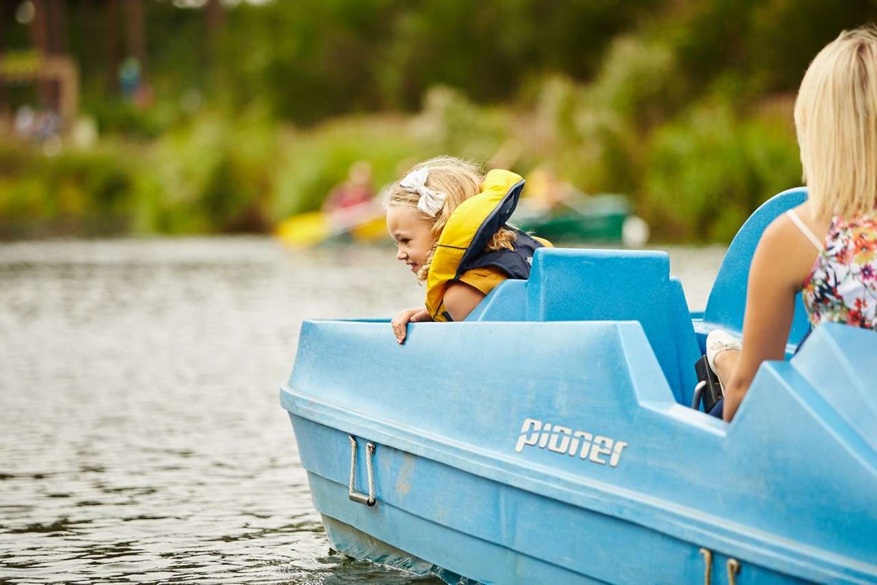 A little girl looking over the side of a pedalo