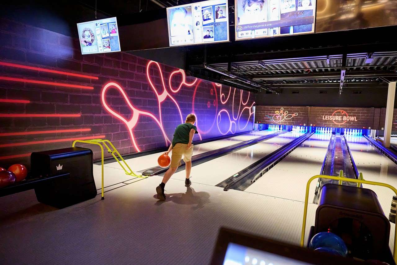 A boy throwing a bowling ball 