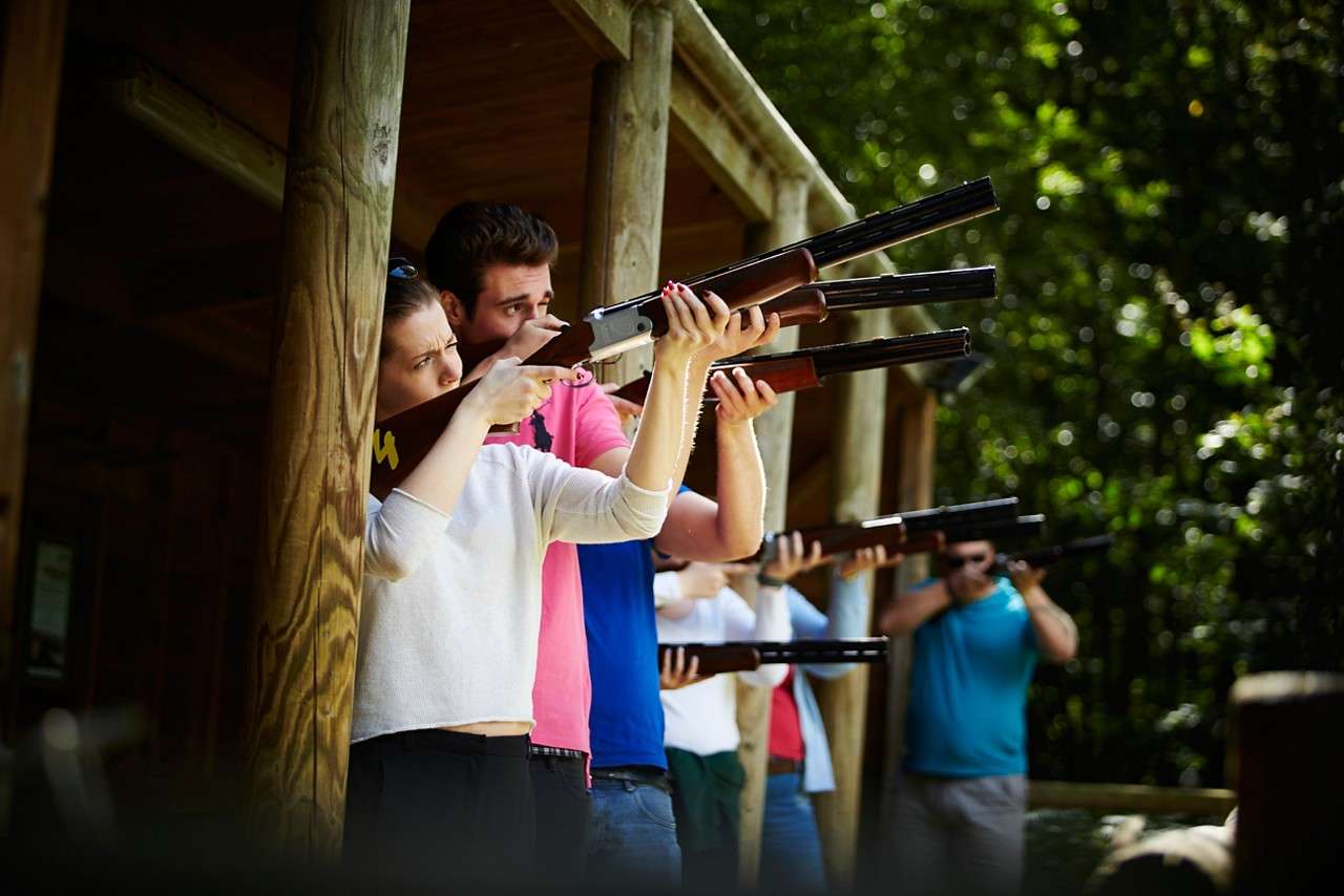 A row of people aiming