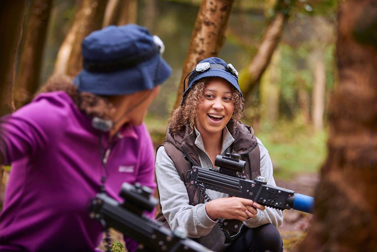 Two people running and smiling at each other. 