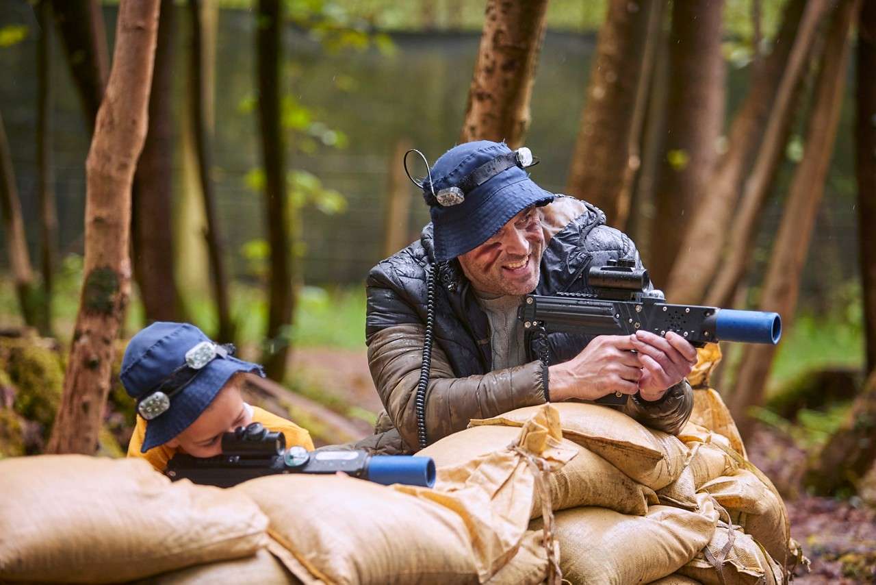 People hiding behind sand bags getting ready to shoot 