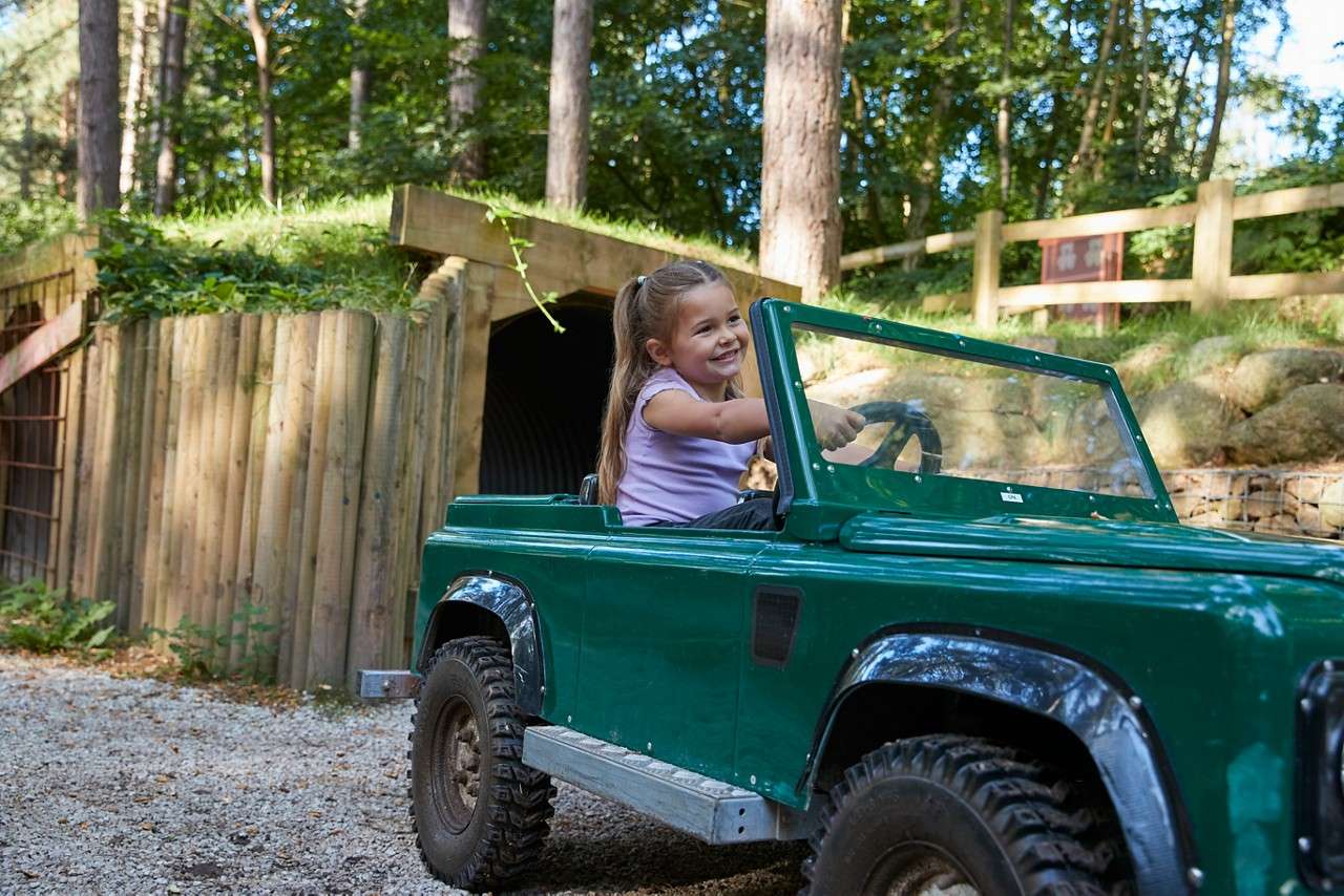 A pre-schooler riding her Land Rover. 