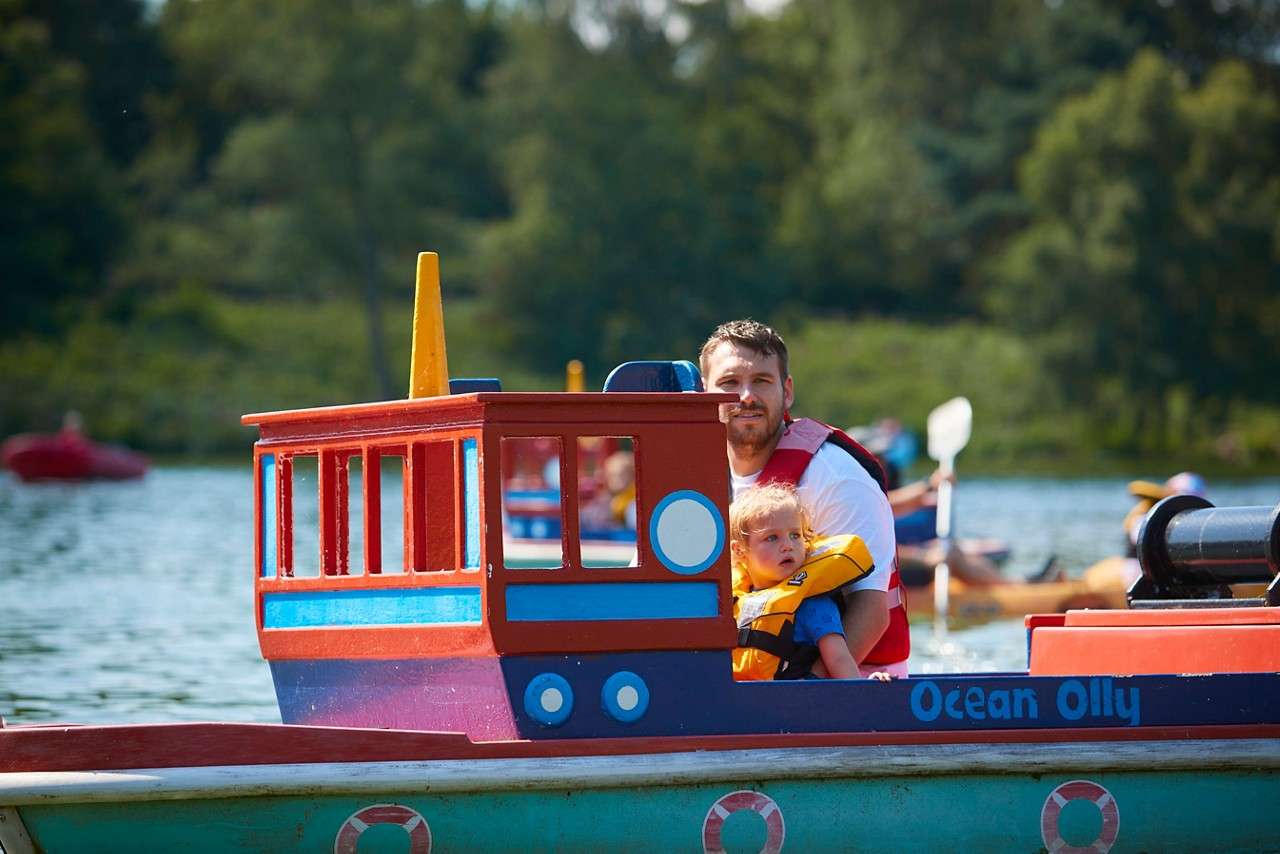 Young boy and adult in the Mini Captain boat