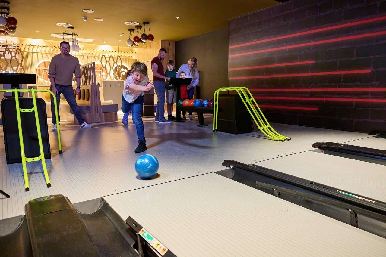 A child throwing a bowling ball