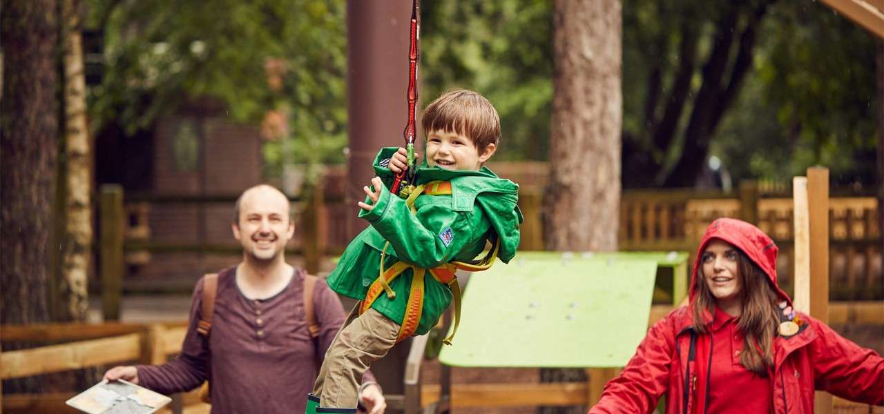 Young boy going across a zip line on the Mini Trek course.