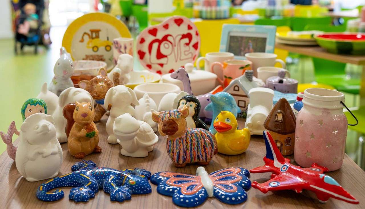 A collection of pottery items including aircraft, butterfly and duck.