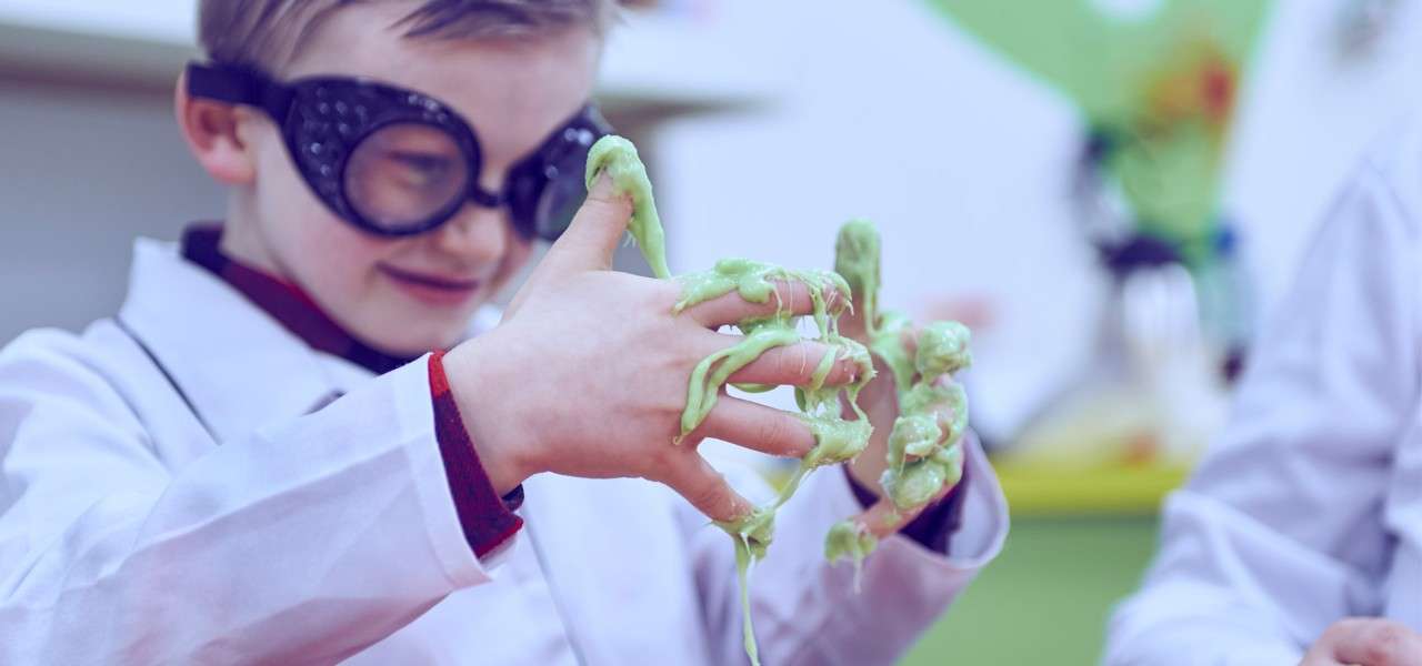 young boy with slime on his hands