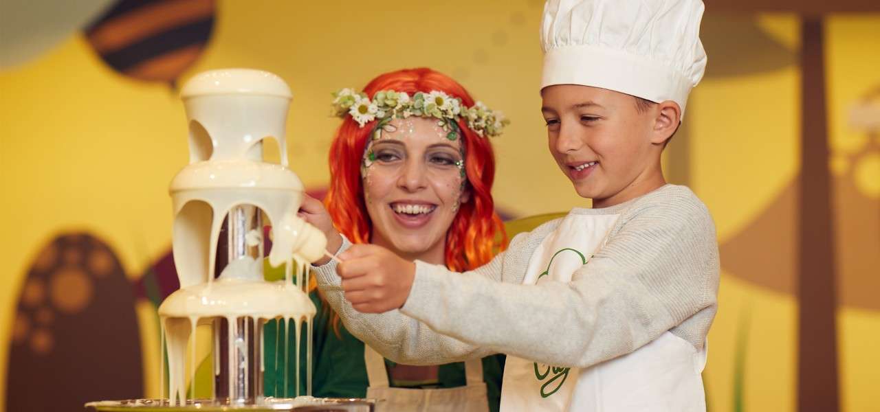 Child and instructor with chocolate fountain