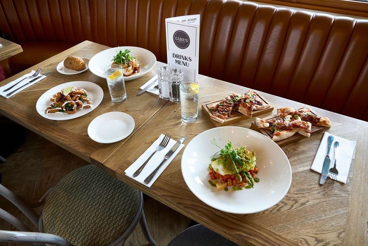 A selection of dishes from the Cara's menu, including wood fired pizzas.