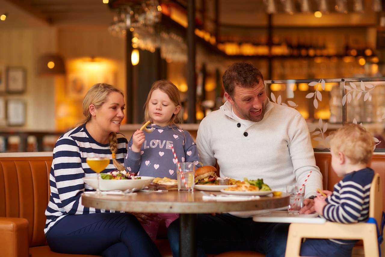 Family sitting around a table in the Cara's restaurant. 