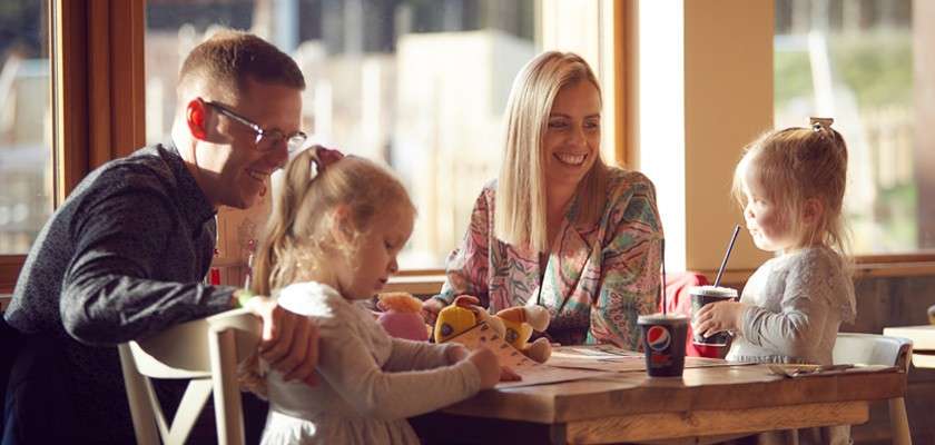 Family sitting around a table in Huck's. 
