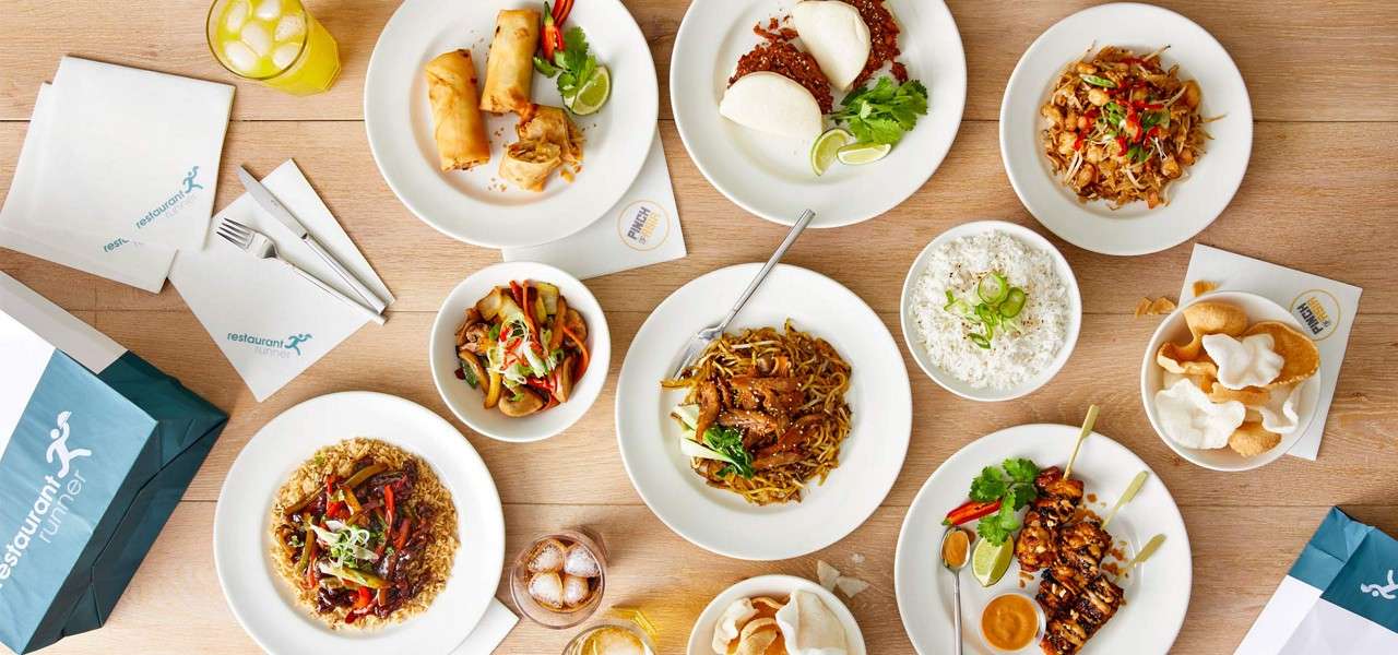Pinch of Asia dishes including bao buns, rice, prawn crackers, and noodles