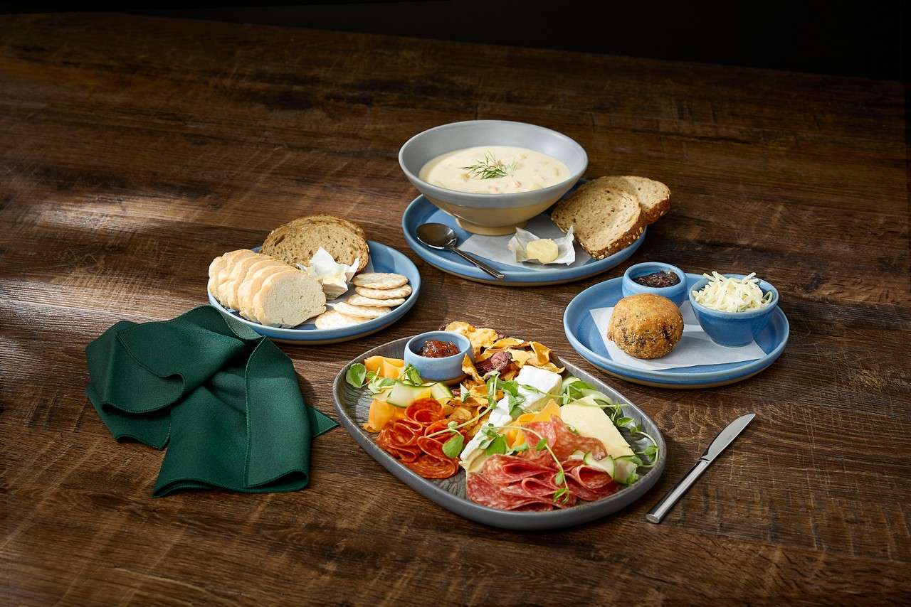 A selection of starters including, soup with crusty bread, antipasti and a scotch egg.