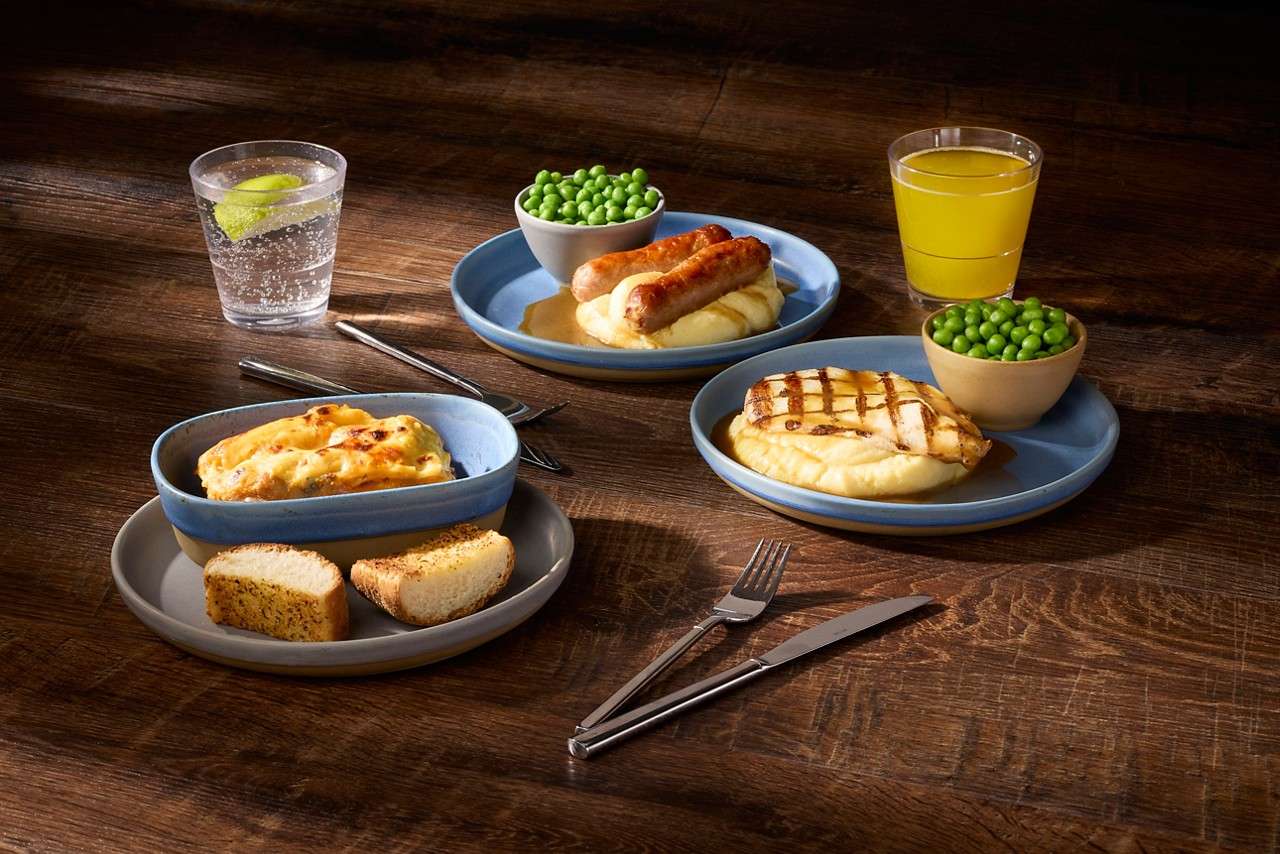 A selection of dishes from The Little Swan's menu including sausage and mash, pasta and peas.