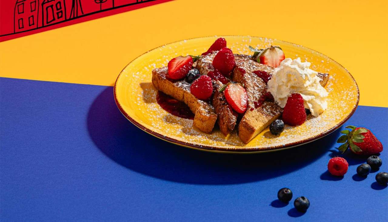 Sweet French Toast topped with fresh red fruits, raspberry compote and fresh whipped cream.