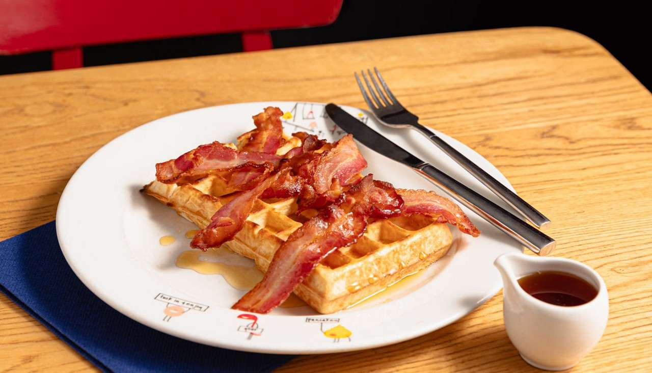 Waffle topped with crispy bacon.