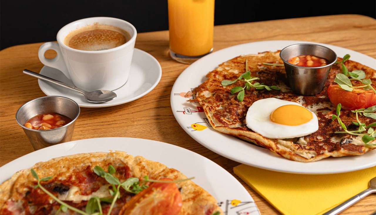 Omelettes topped with breakfast items. 