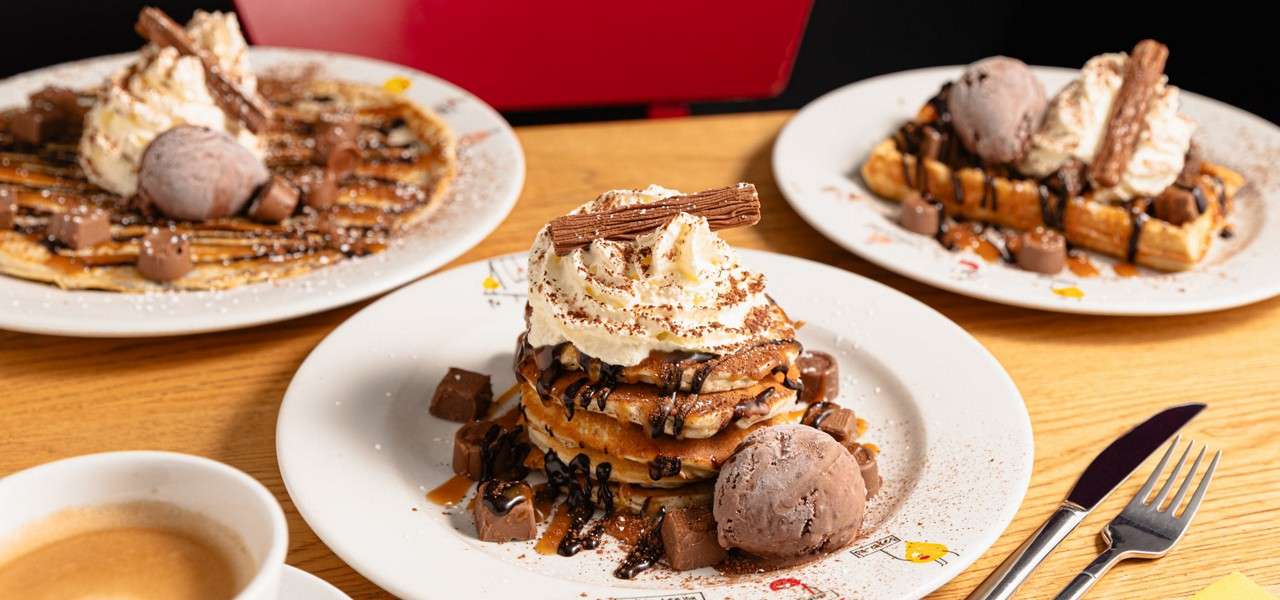 Pancake topped with ice cream and chocolate sauce.