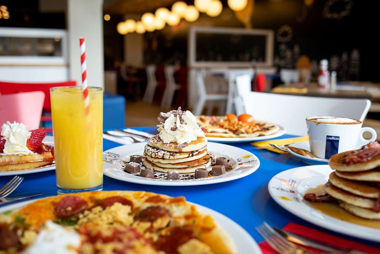 A table with multiple dishes of pancakes 