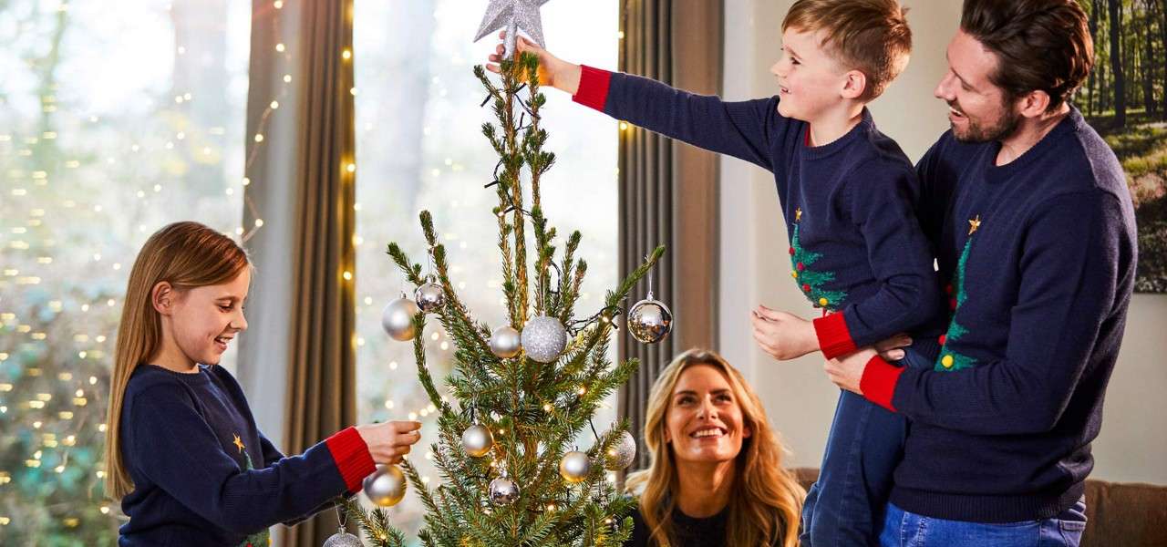 Family decorating a Christmas Tree