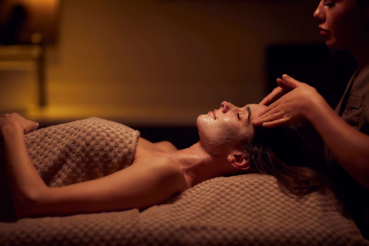 A women lying on a spa bed getting a facial