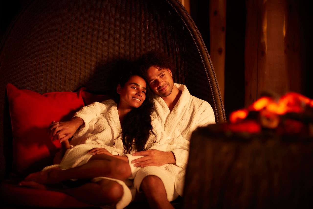 Couple snuggling up in the Fireside Relax.