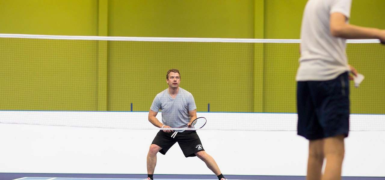 Two men playing badminton