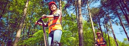 People riding Segways through the forest