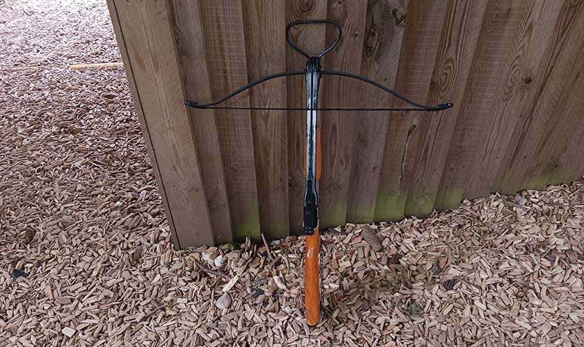 Crossbow propped against a wall
