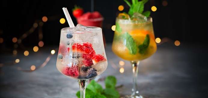 Fruity cocktails topped with fresh fruit.