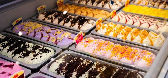 Colourful ice creams topped with tasty toppings.