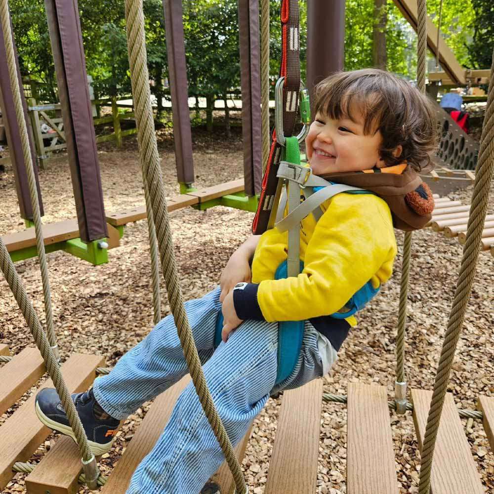 A young child on the Mini Trek activity smiling.