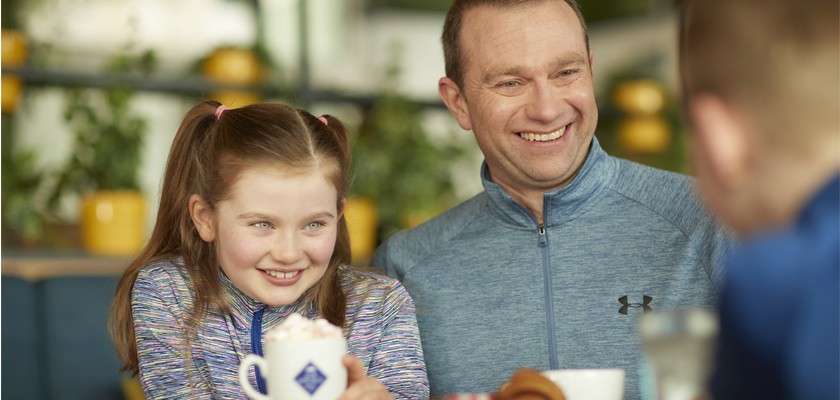 father and daughter in coffee house