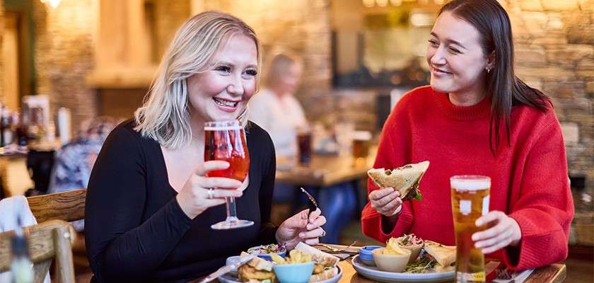 Group laughing in the bowling alley.