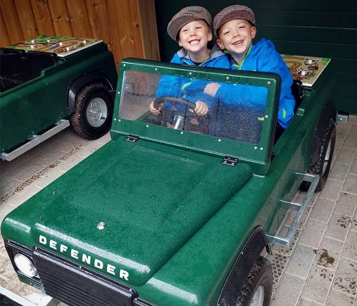 Children in a  toy Defender