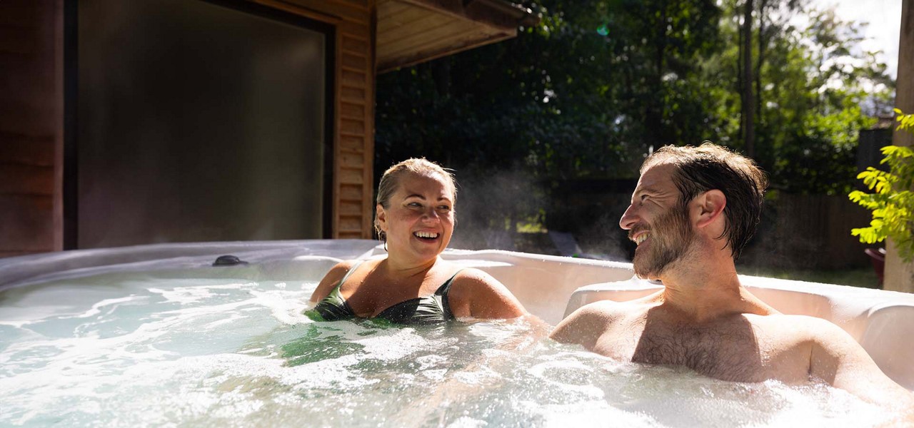 A couple sat in a hot tub together.
