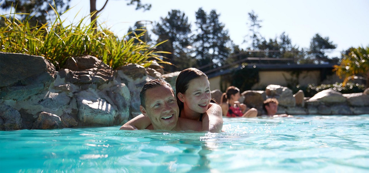 Father and daughter splashing in the Subtropical Swimming Paradise