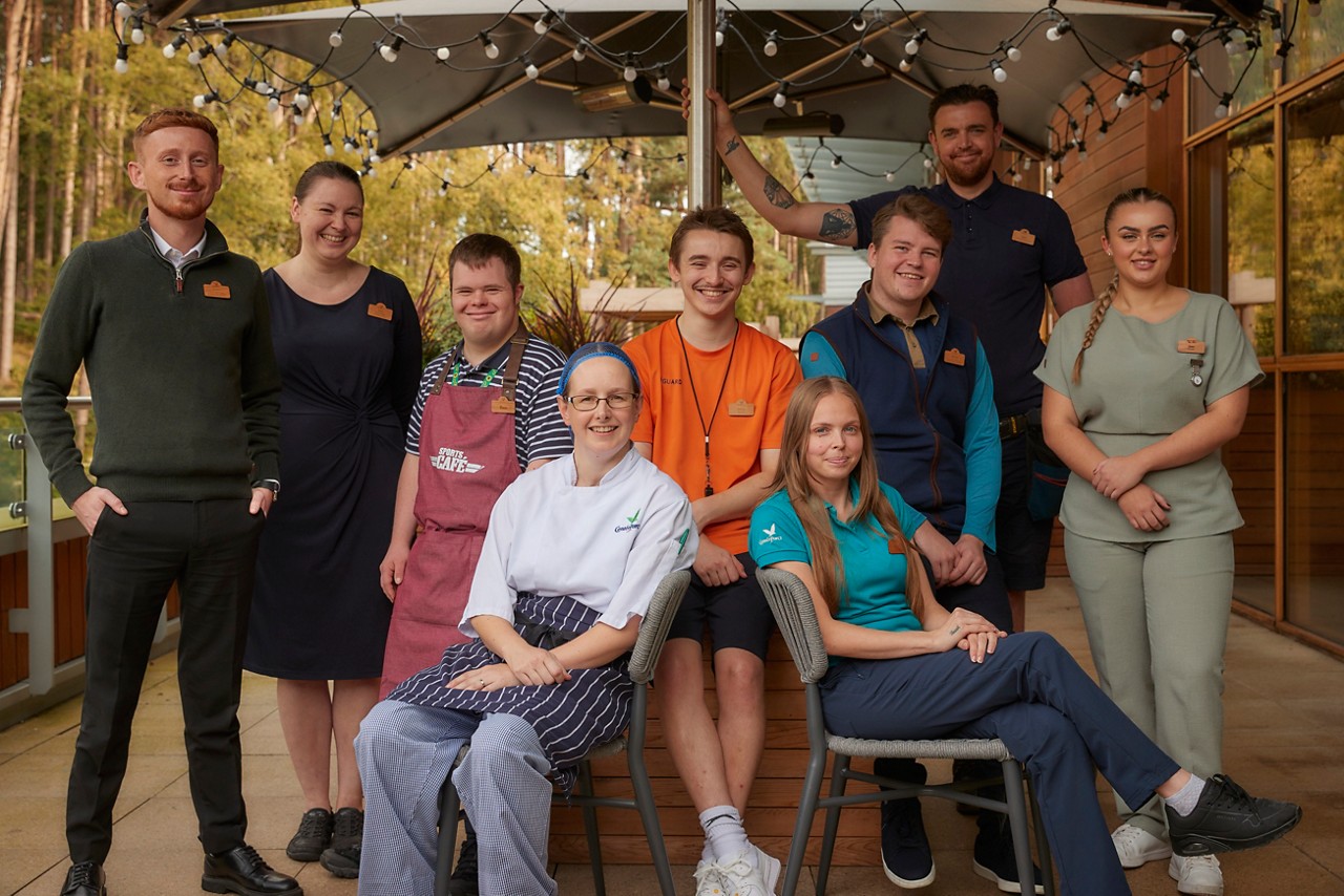 A group of staff members in front of the lake