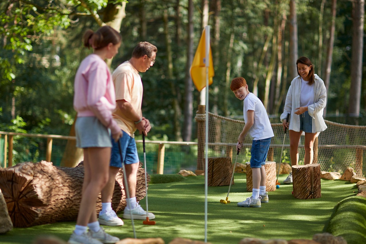 Family playing Adventure Golf.