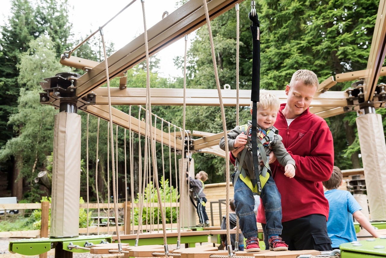 Young person tackling the Mini Trek course with the help of an adult.