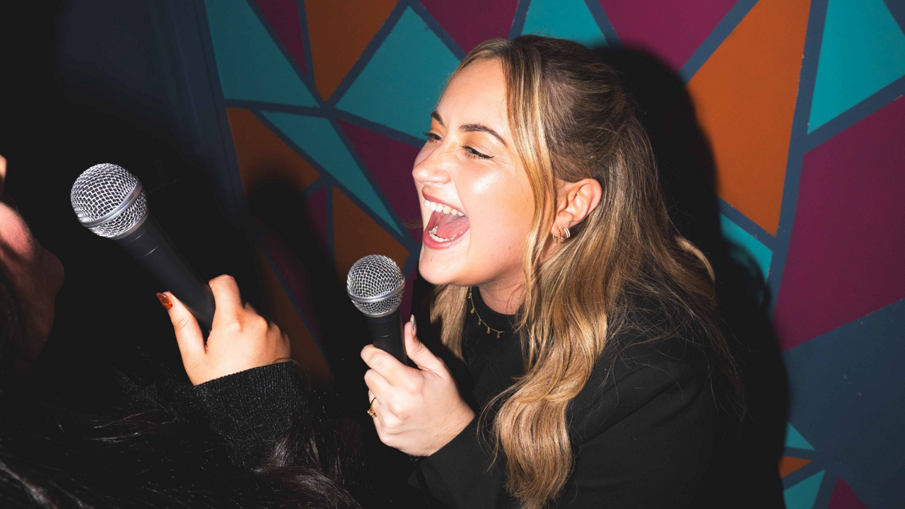 Woman singing into a microphone