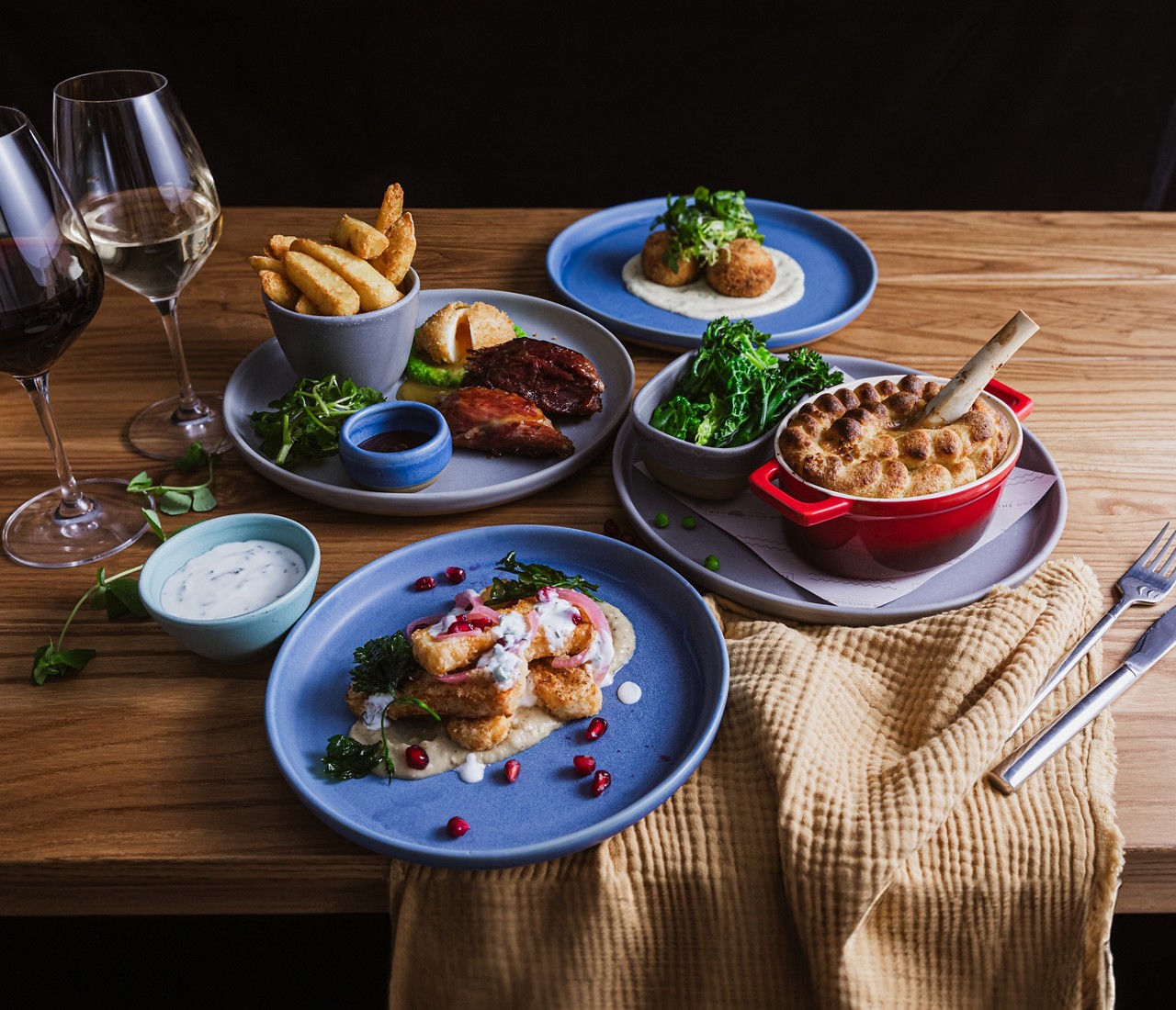 Dishes from The Dozing Duck menu, including pie, chicken wings, chunky chips and fish cakes.