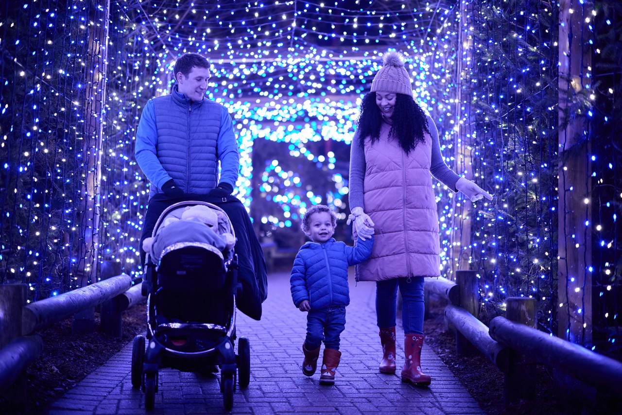 Couple enjoying hot chocolate at Winter Forest Lights.